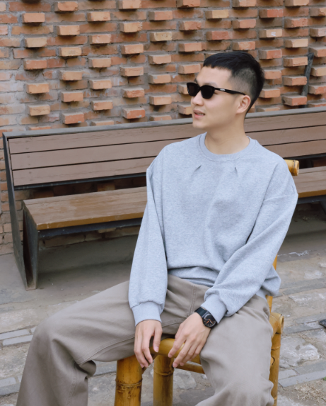 A person sitting on a benchDescription automatically generated