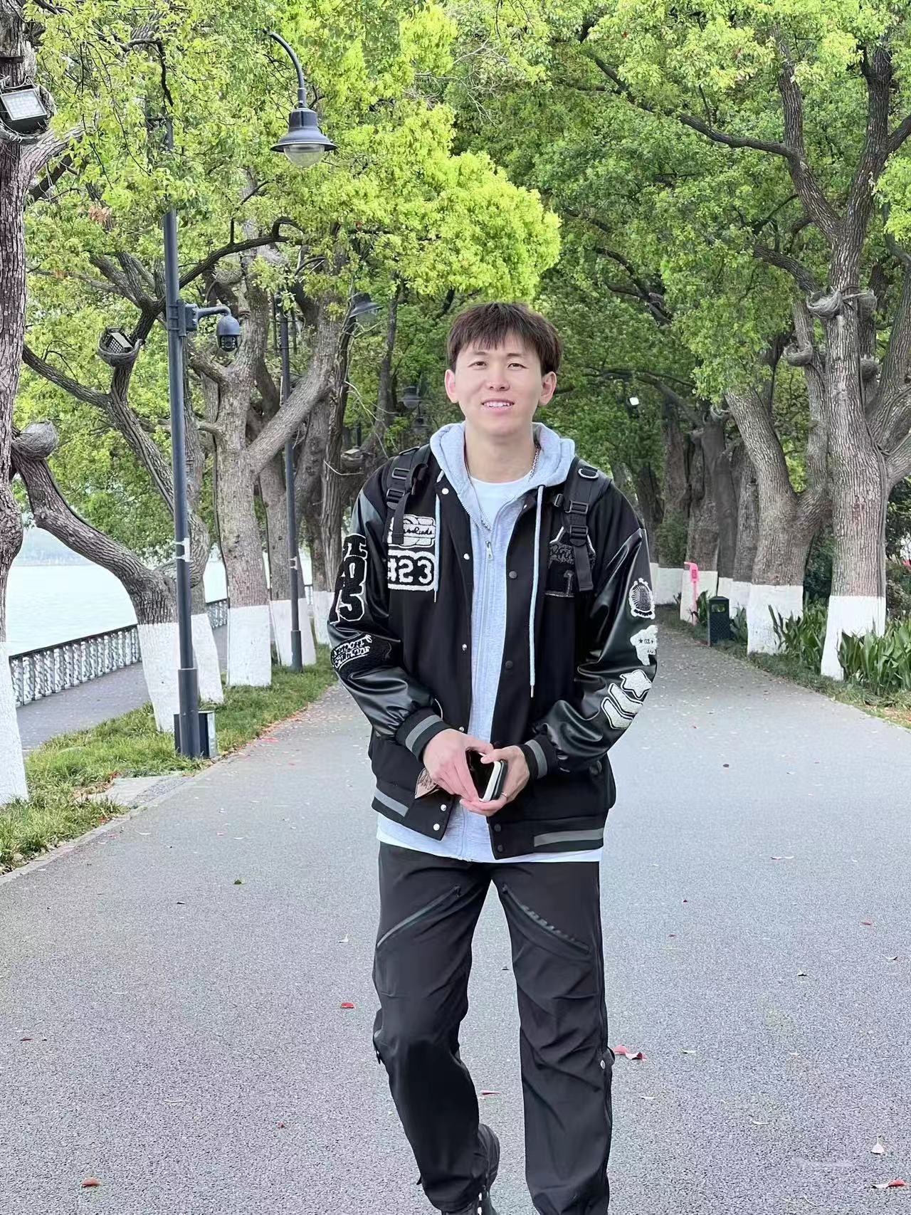 A person standing on a sidewalkDescription automatically generated